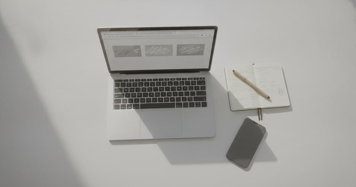 Desk with laptop and notebook representing NoteGPT alternatives for YouTube transcripts